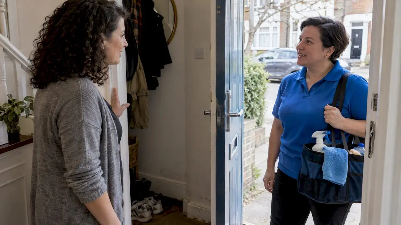 Homeowner speaking with an arriving cleaner